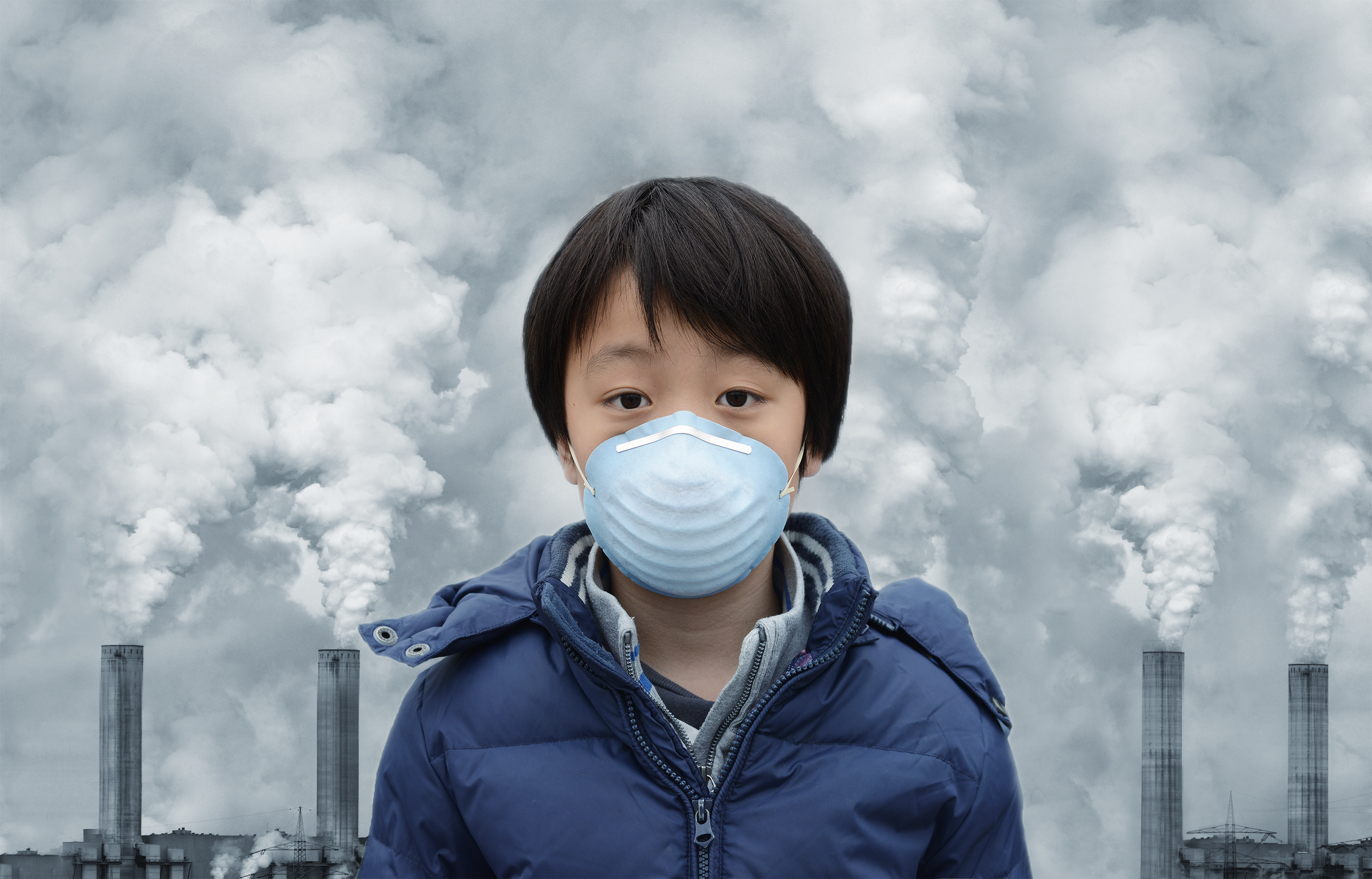 An image of a youth in front of a polluted sky.